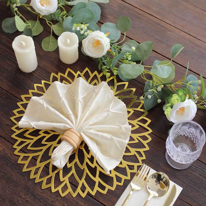 Elegant table setting with napkin, candles, and greenery accents.
