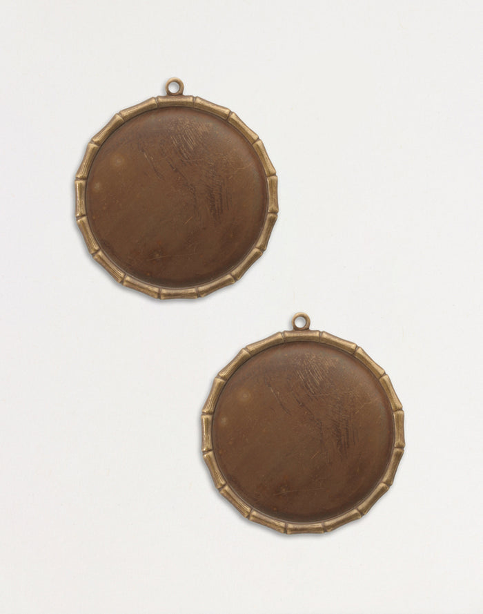 Two antique bronze round frames