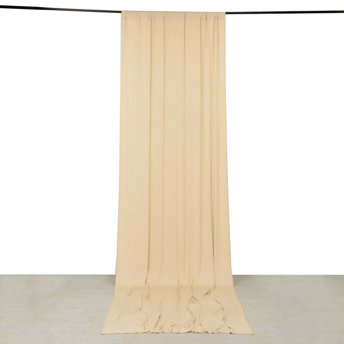 Beige fabric backdrop hanging from a rod for photography or staging purposes