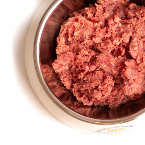 Big Country Raw Beef Dinner in a stainless-steel bowl, featuring finely minced meat mixture, highlighting its complete nutrition with Canadian beef, organs, fruits, and vegetables.