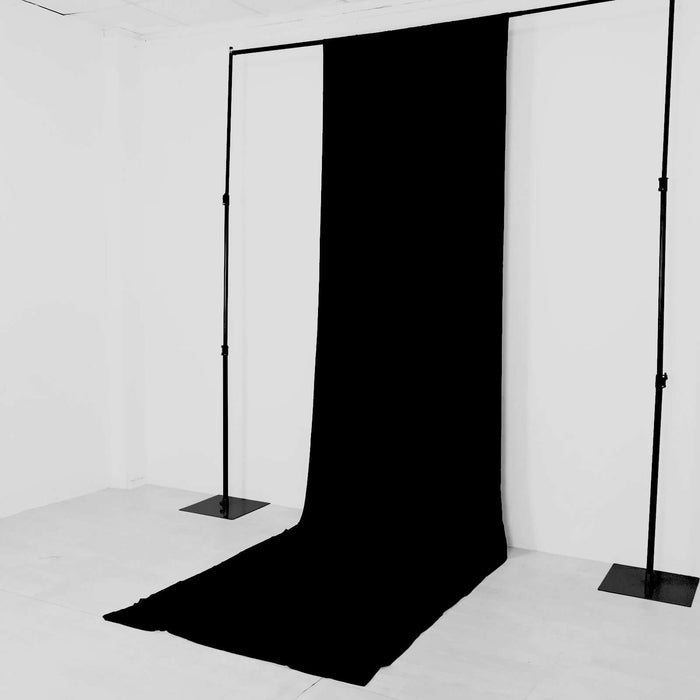 Black backdrop draped on a studio stand for photography