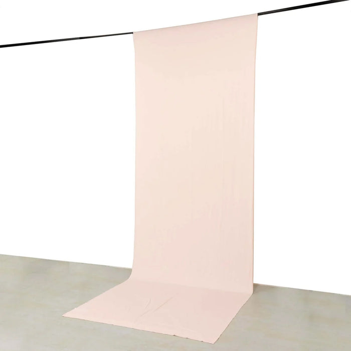 Soft blush pink seamless backdrop on a hanging studio paper roll