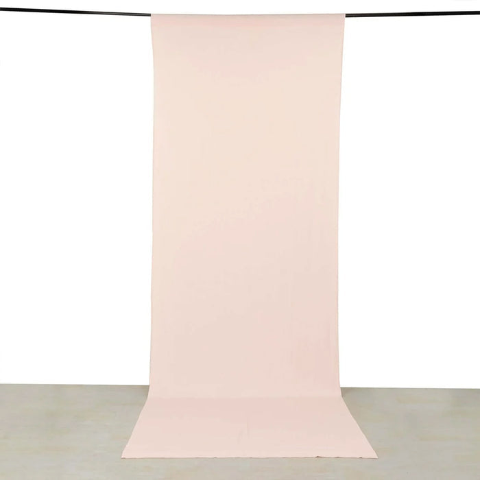 Soft pink seamless paper backdrop hanging from a studio backdrop pole