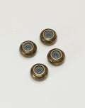 Four antique brass beads with grey centers