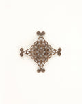 Detailed filigree cross ornament on white background