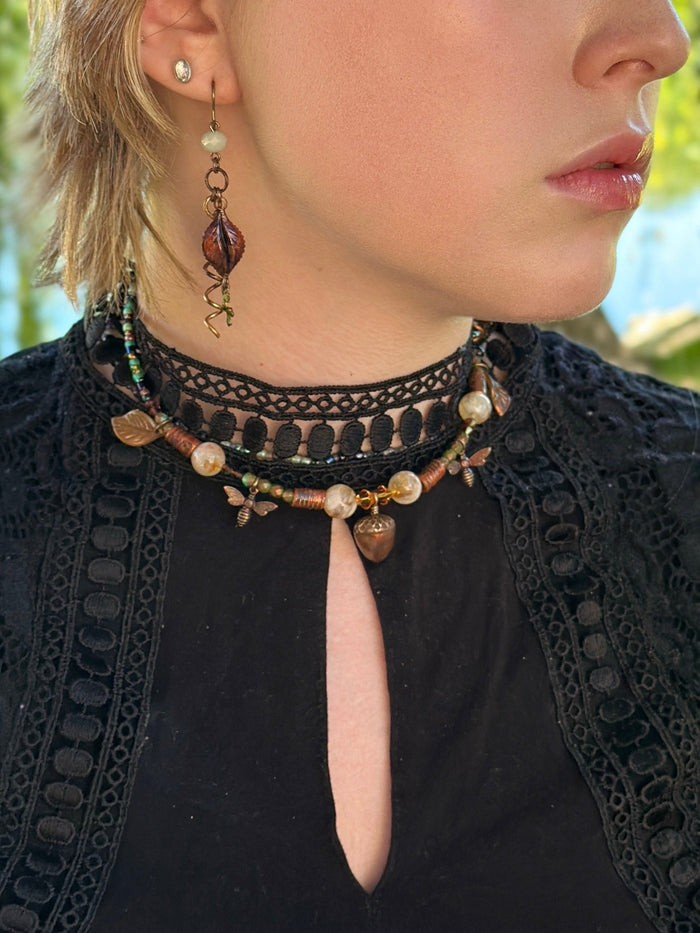 Woman wearing ornate necklace and earring.