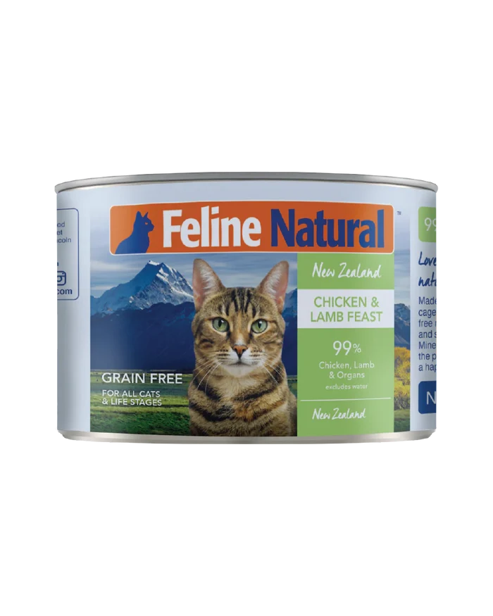 Feline Natural Canned Food for Cats: New Zealand Chicken & Lamb Feast, 99% meat, with a tabby cat in front of a mountain landscape on the label.