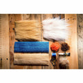 Gangster Crab DIY fly tying kit flat lay with blue thread, orange fur, and brown fibers