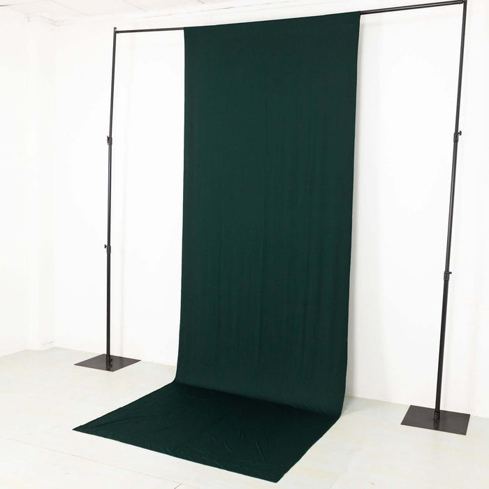 Green backdrop fabric on a studio stand for photography.