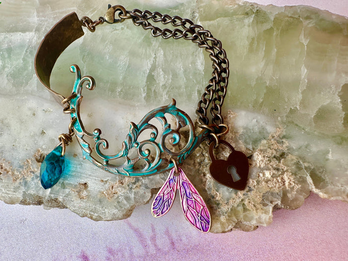 Bracelet with charms on a textured surface.