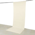 Beige fabric backdrop on a grey surface for photography and staging.