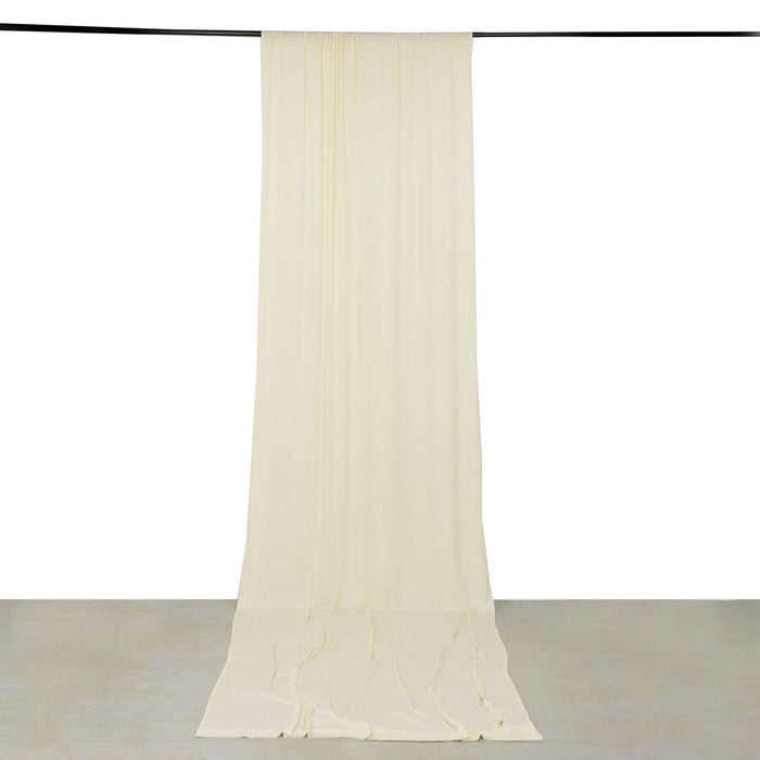 Cream fabric drape hanging on a rod, showcasing its full length and smooth texture.