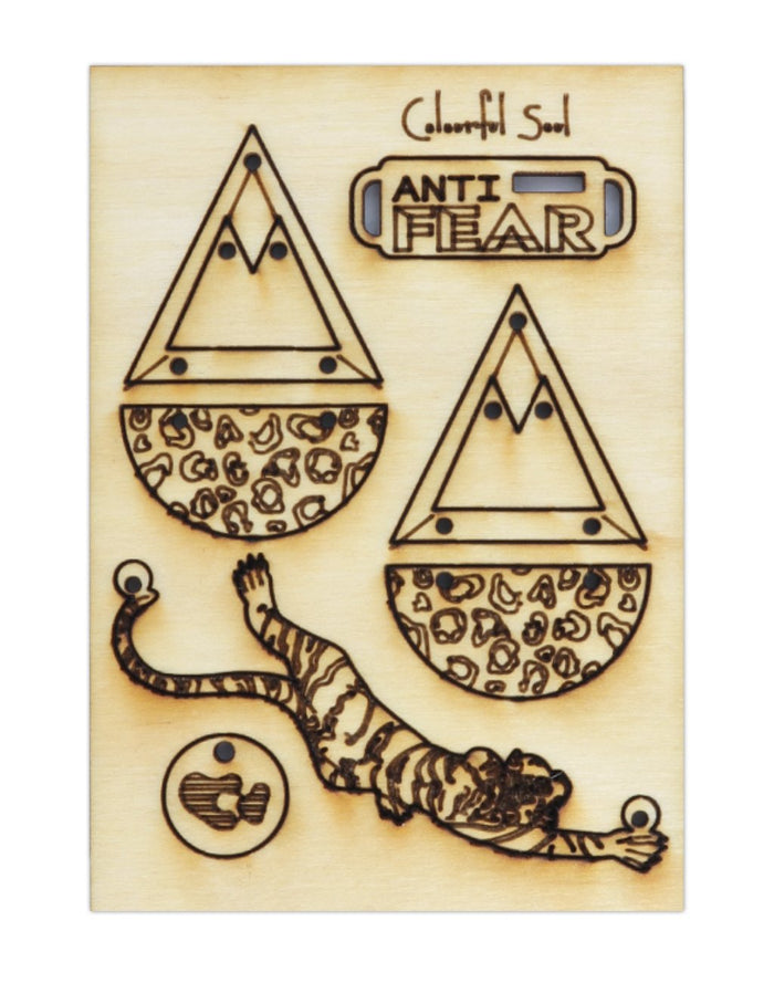 Wooden art with tiger, Anti Fear design, and geometric shapes.
