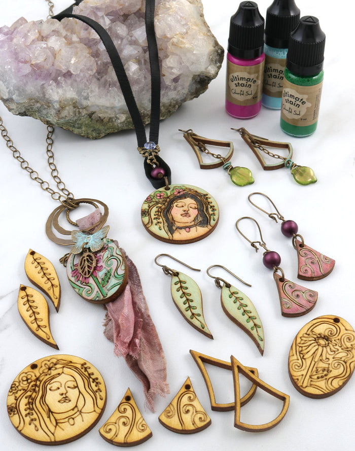 Handmade jewelry with wood, ink, and crystals