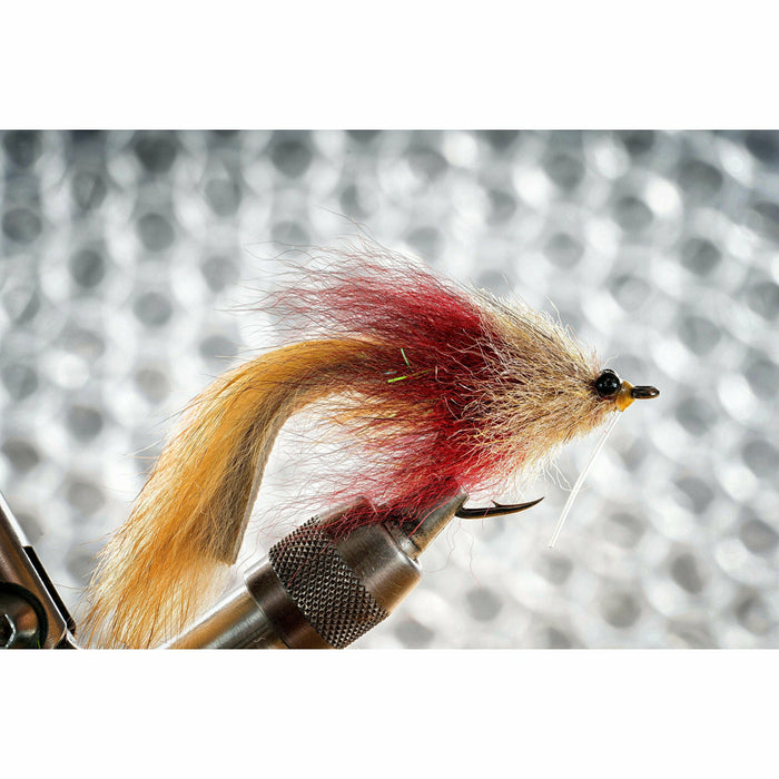 Close-up of finished fly tying pattern from Megalolipop kit showing arctic fox tail and yellow hard head