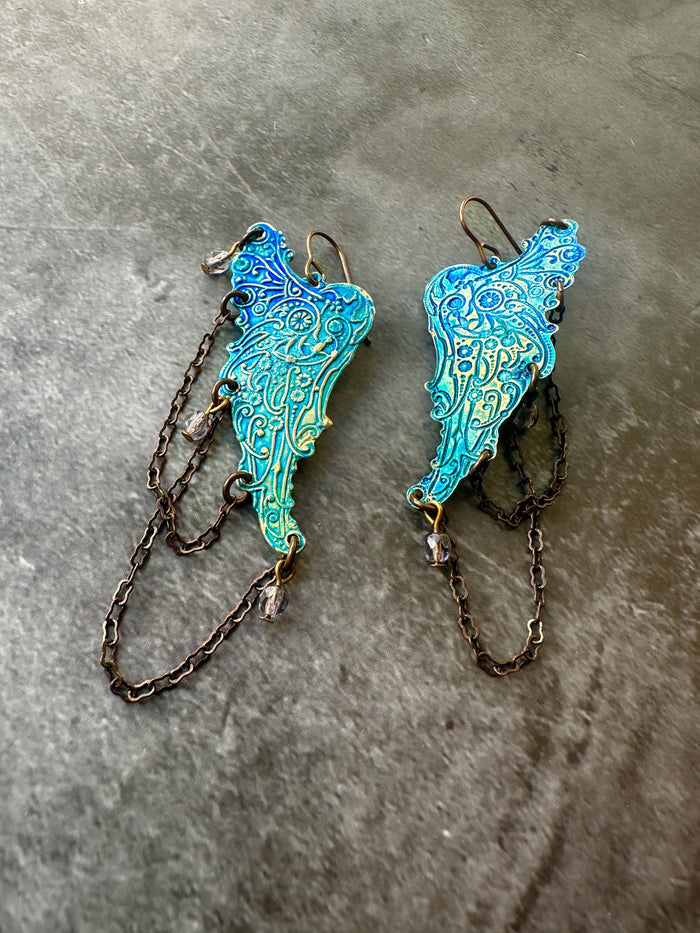 Blue and turquoise wing-shaped earrings with chains.
