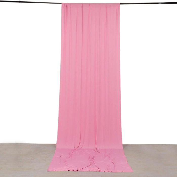 Pink fabric backdrop hanging in studio setting