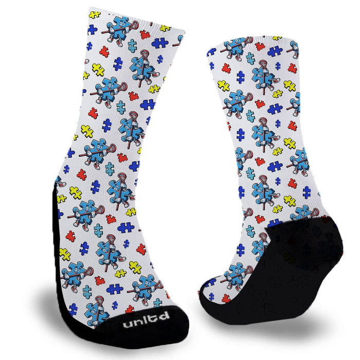Blue puzzle piece holding lacrosse stick surrounded by smaller puzzle pieces on a white sock