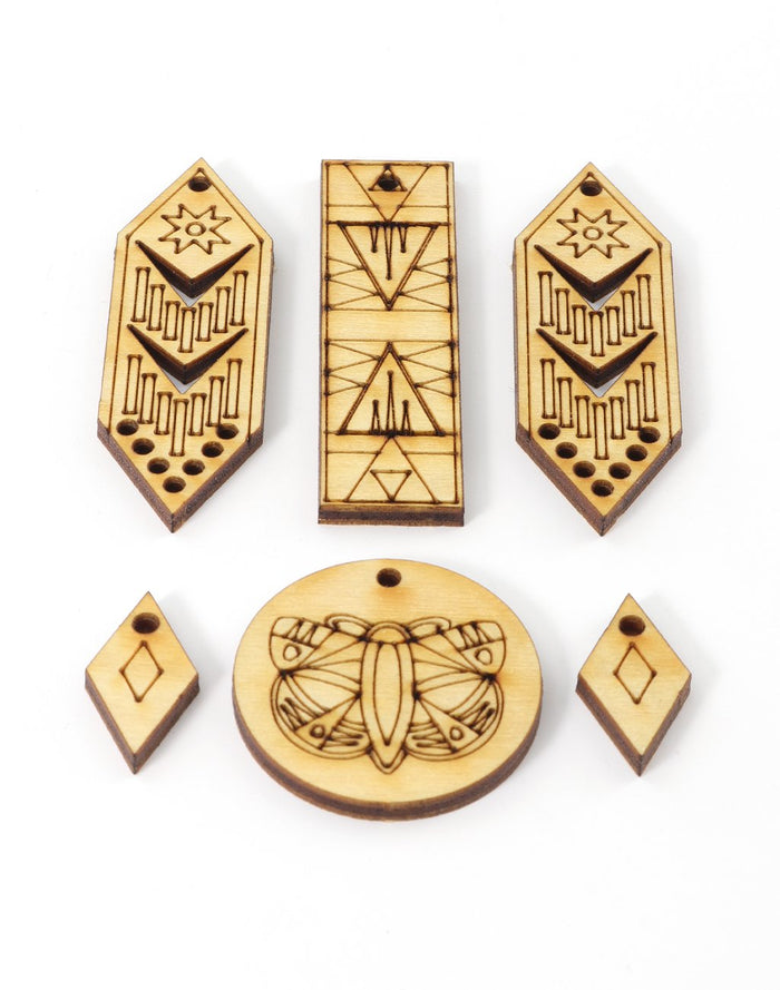 Laser-cut wooden jewelry pieces with geometric designs