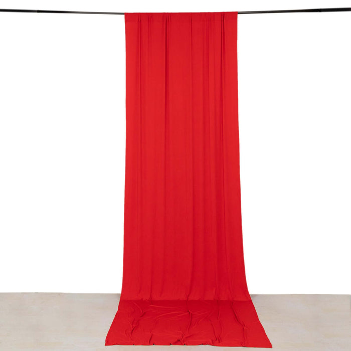 Red fabric drape on a studio backdrop.