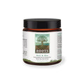 Small amber glass jar with black lid, labeled Soil & Sea Primordial Pre & Probiotics - Roots by Adored Beast, featuring a stylized tree design.