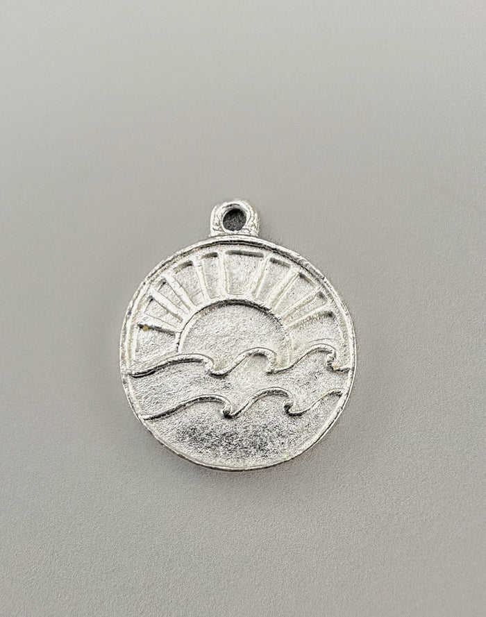 Silver Sun and Wave Charm