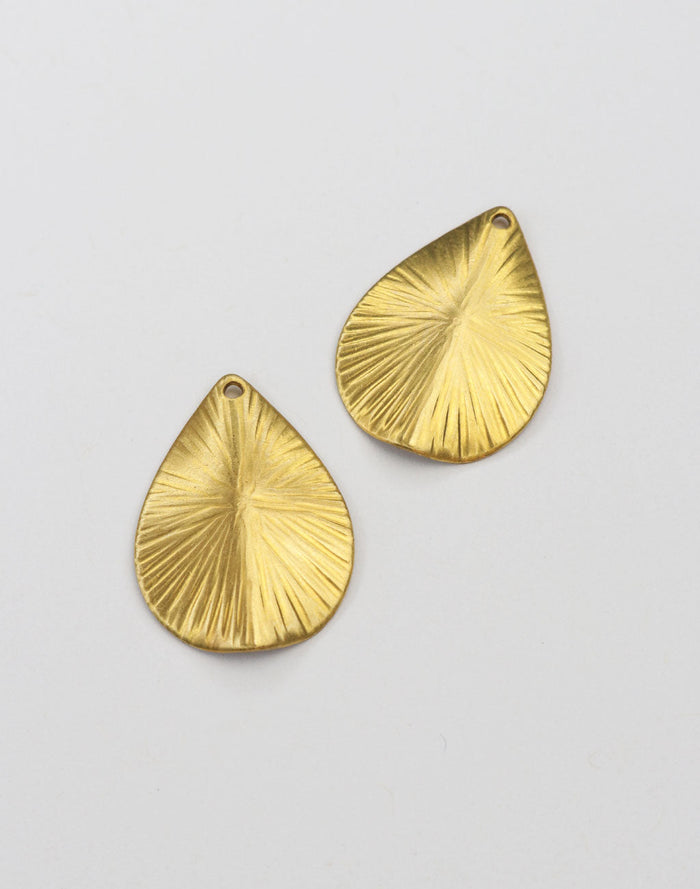 Gold teardrop pendants with textured design.
