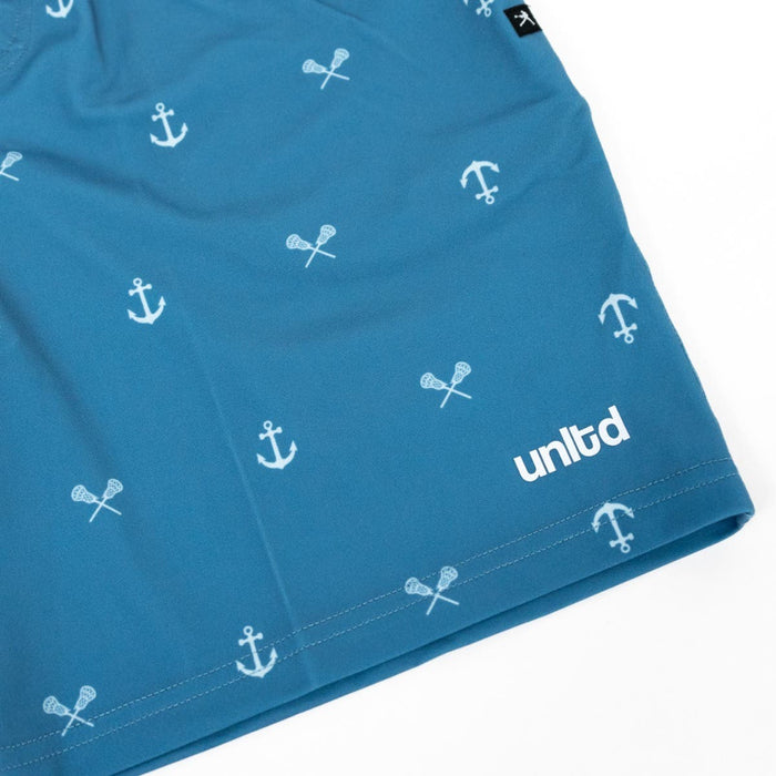 Tonal Anchors Tactical 3.0 Youth lacosse shorts zoomed in on left thigh with unltd logo and anchor/lacrosse stick pattern