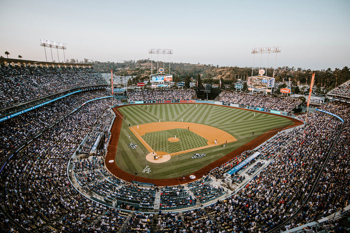 Baseball stadium during a game with a large crowd and clear sky.